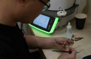 Dental technician working on implants using the Ivoclar Programat P710.