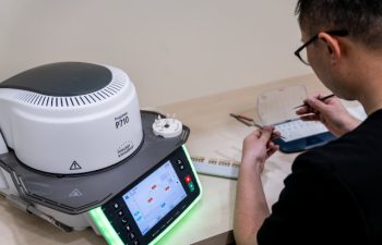Dental technician working on implants using the Ivoclar Programat P710.