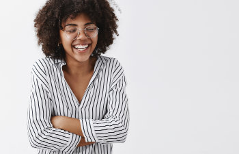 laughing girl with glasses and striped shirt